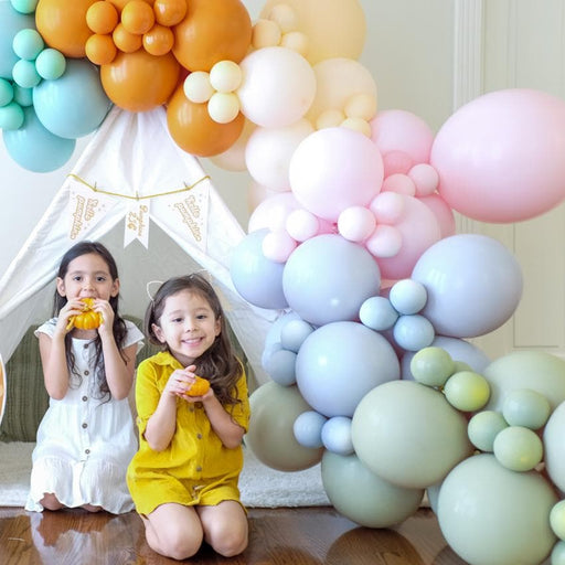 fall balloon garland with 2 girls